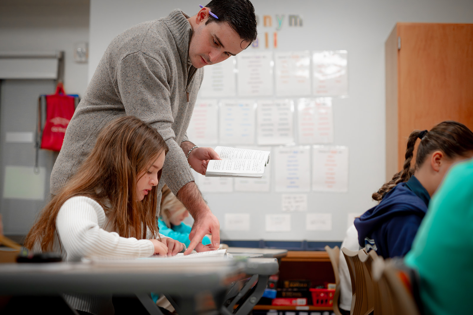 Teacher helping a student in classroom