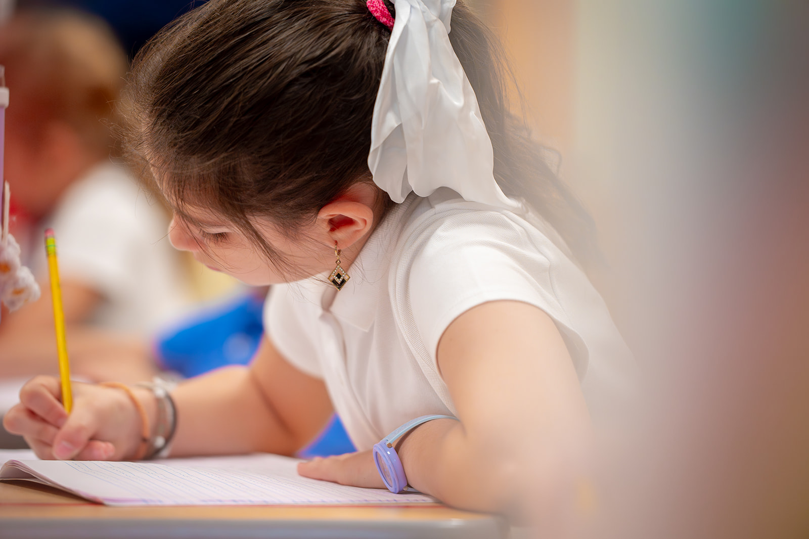girl writing on paper with pencil