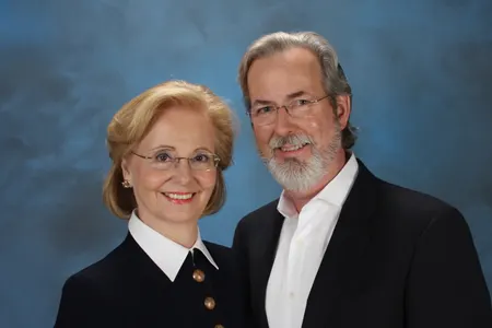 An older woman and man smiling wearing glasses