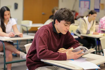 Boy looking at his school work