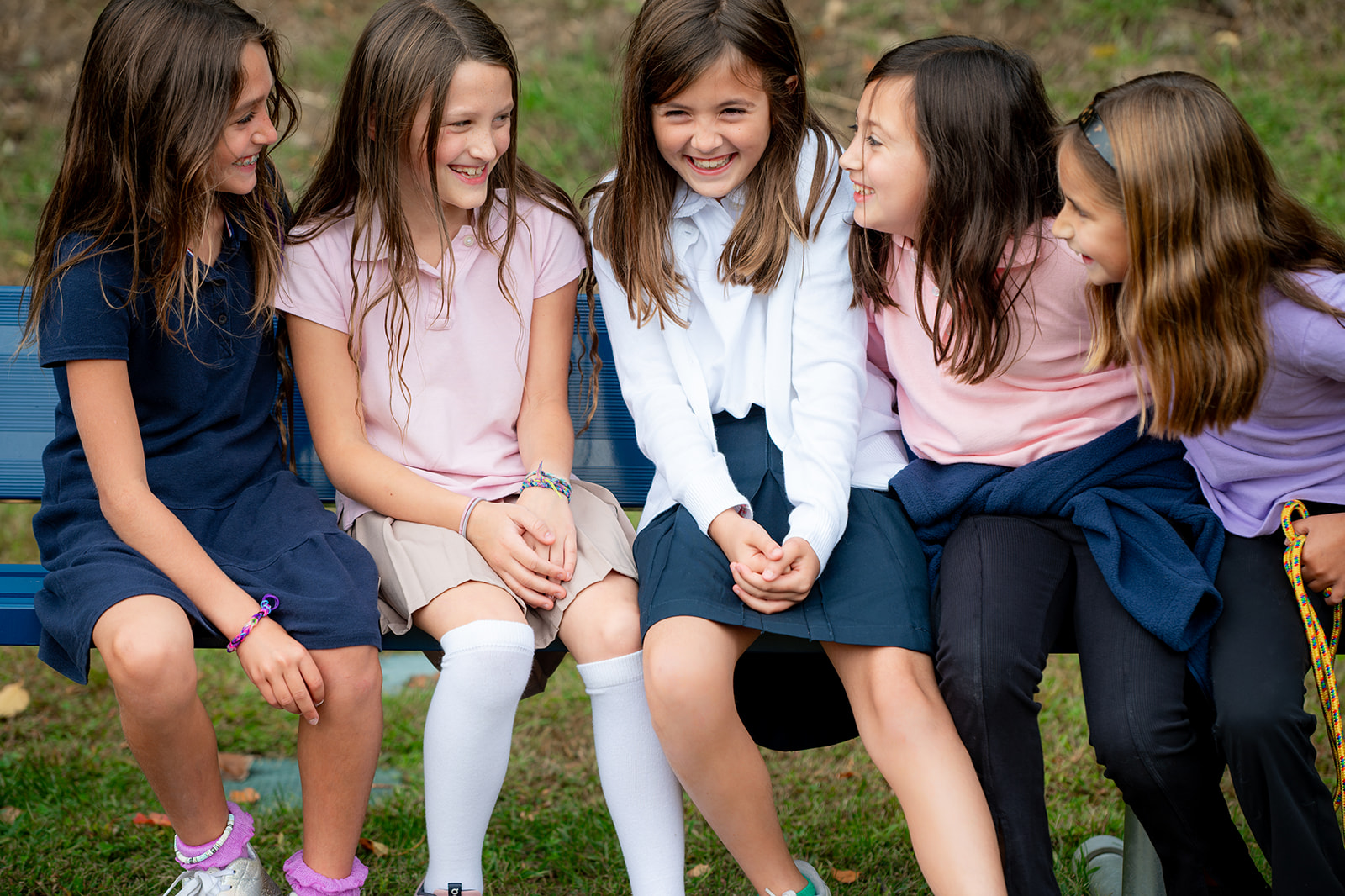 Five girls laughing and smiling together