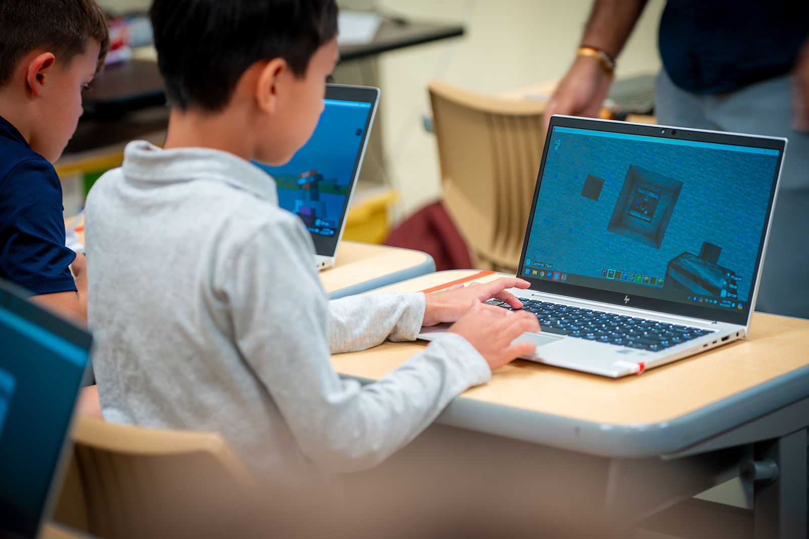Student using a laptop while sitting at a desk