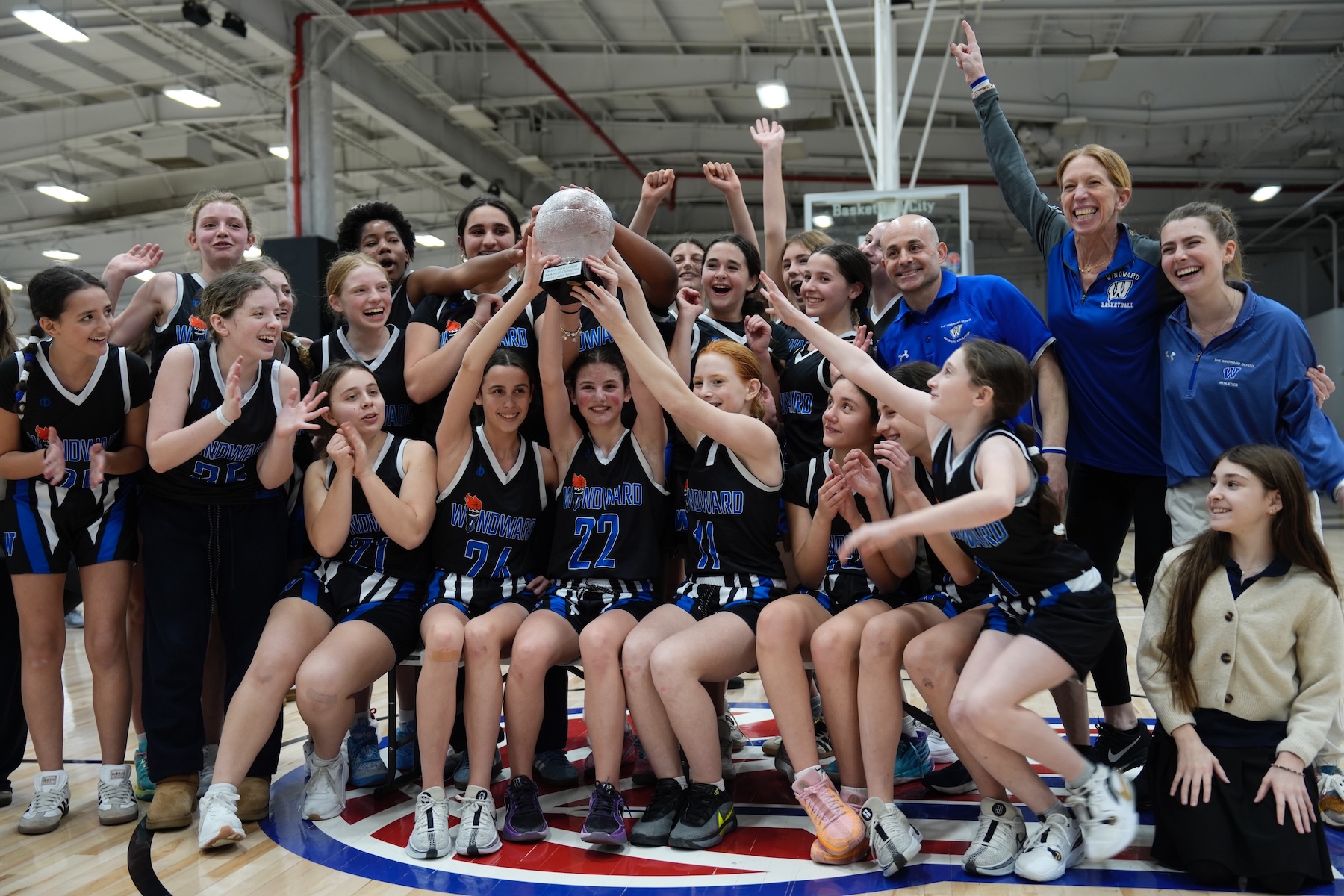 windward volleyball team celebrating a win