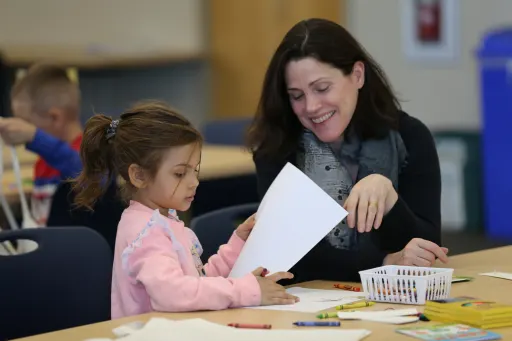 windward institute teacher hands on learning with young female student